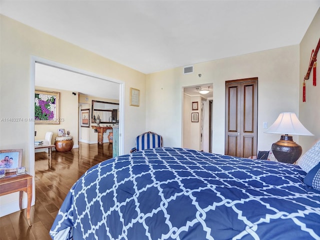 bedroom with hardwood / wood-style flooring