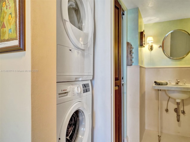 laundry area featuring stacked washer and dryer