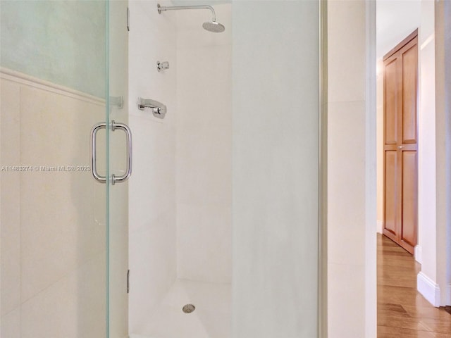 bathroom featuring an enclosed shower and hardwood / wood-style floors