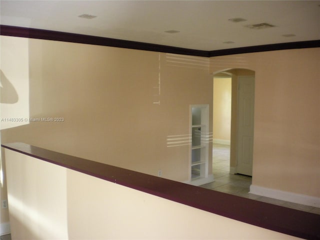 interior details featuring light tile flooring and ornamental molding