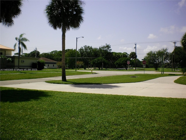 view of property's community with a lawn