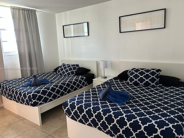 tiled bedroom with a textured ceiling