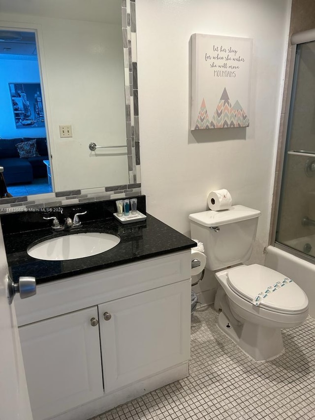 full bathroom with shower / bath combination with glass door, vanity, toilet, and tile flooring