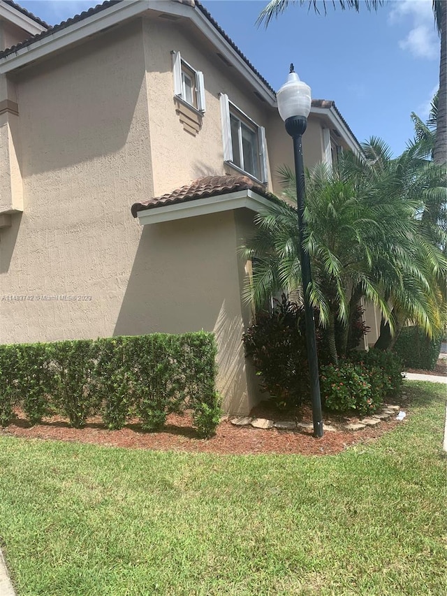 view of side of home with a lawn