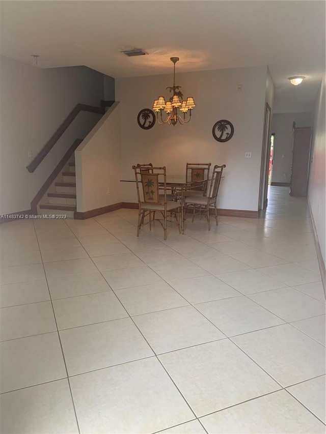 unfurnished dining area featuring light tile floors and a chandelier