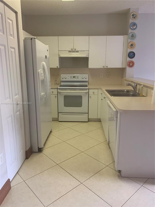 kitchen with white appliances, white cabinets, sink, and light tile floors