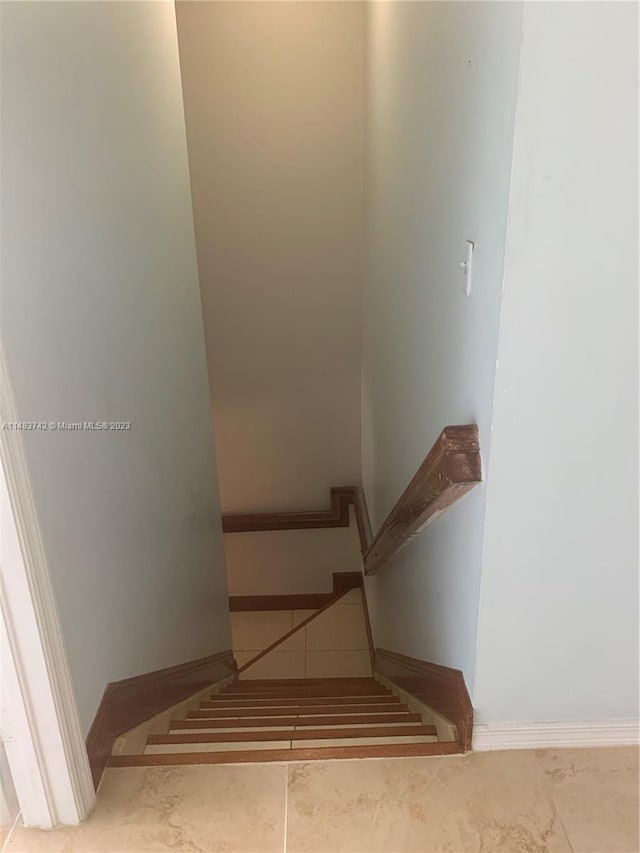 stairs with light tile floors