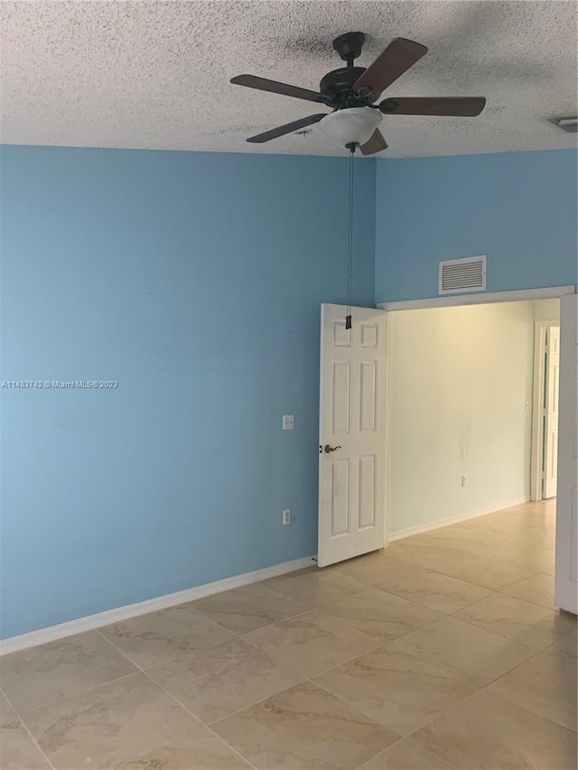 tiled spare room with high vaulted ceiling, a textured ceiling, and ceiling fan