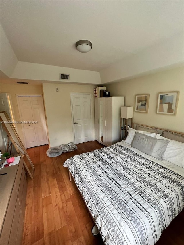 bedroom with dark wood-type flooring