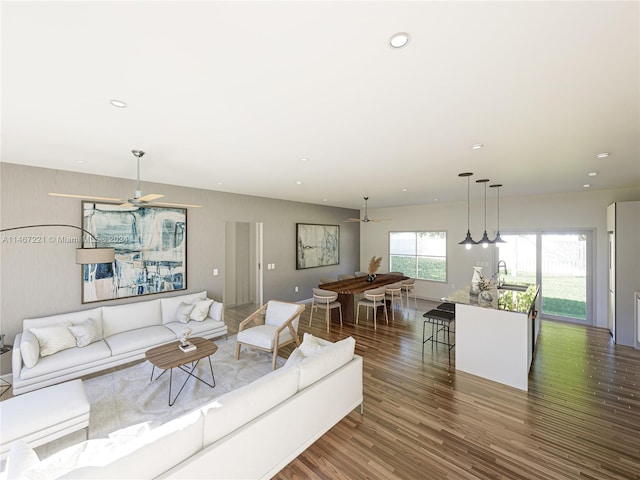 living room with ceiling fan, sink, and dark hardwood / wood-style flooring