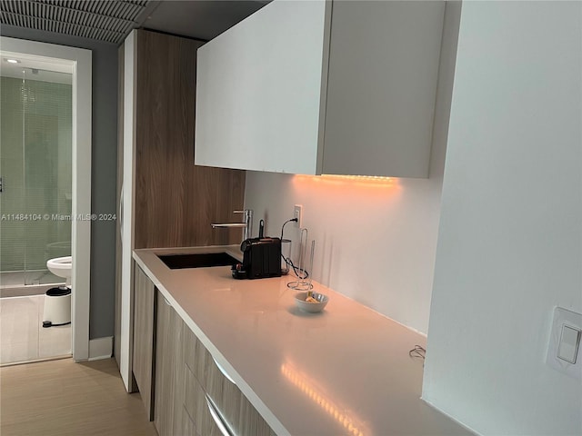 kitchen featuring light tile patterned floors and sink