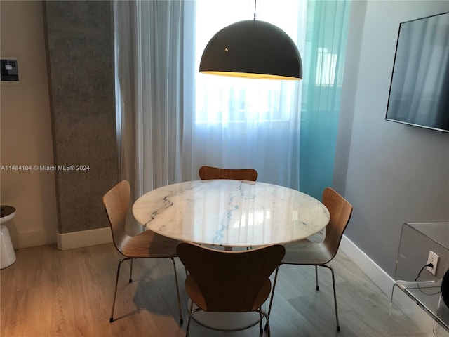 dining space with light hardwood / wood-style flooring and plenty of natural light