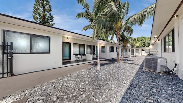 exterior space with central air condition unit and a patio