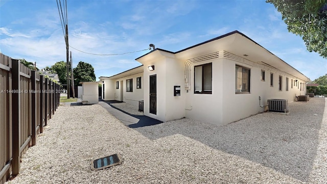 view of home's exterior with central air condition unit and a patio area