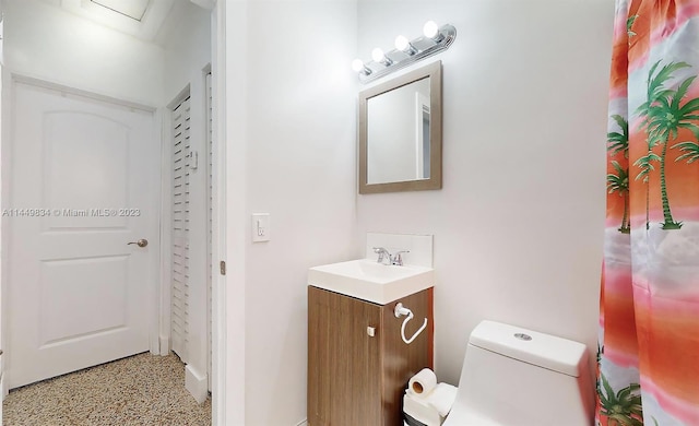 bathroom featuring vanity and toilet