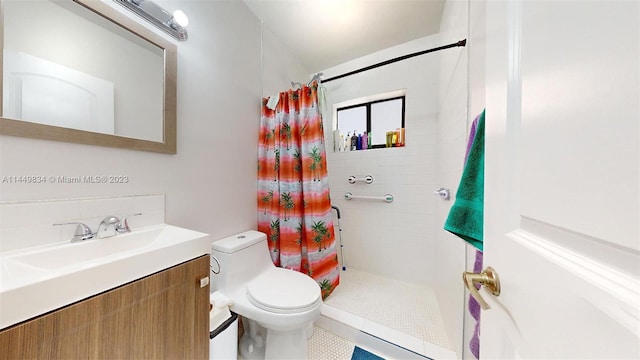 bathroom featuring curtained shower, vanity, and toilet