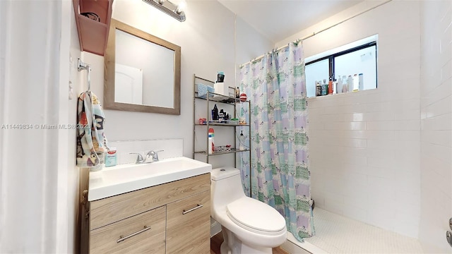 bathroom featuring curtained shower, vanity, and toilet