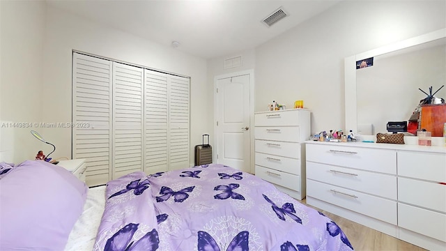 bedroom featuring light wood-type flooring and a closet