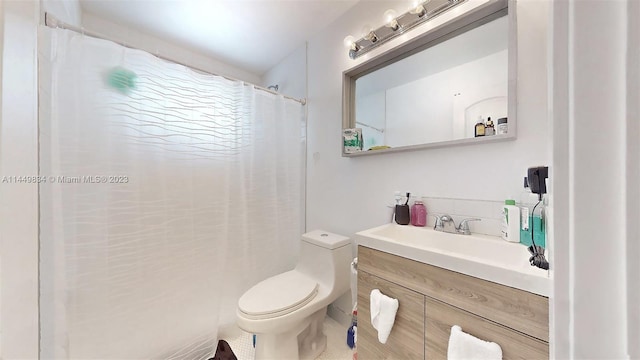 bathroom with curtained shower, vanity, and toilet