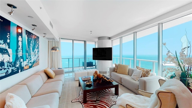 living room with a water view and floor to ceiling windows