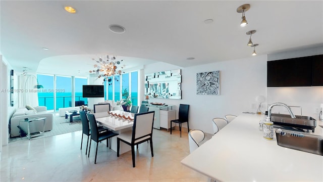 tiled dining room featuring floor to ceiling windows and a notable chandelier