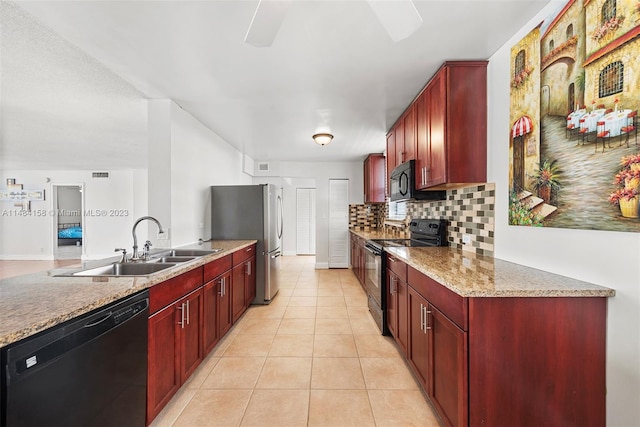 kitchen with light stone countertops, black appliances, tasteful backsplash, sink, and light tile floors