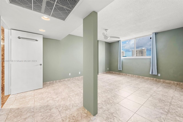 tiled spare room with ceiling fan