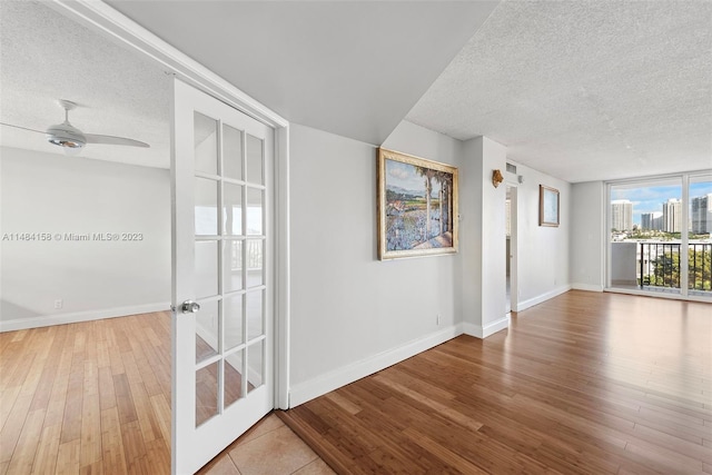 interior space featuring light hardwood / wood-style flooring, ceiling fan, and a textured ceiling