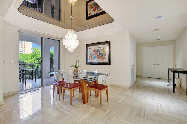 dining space with light parquet floors, a raised ceiling, and a notable chandelier