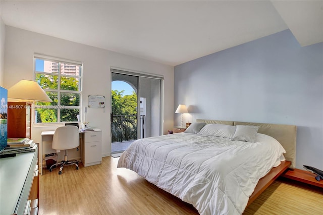 bedroom featuring access to outside and light hardwood / wood-style floors