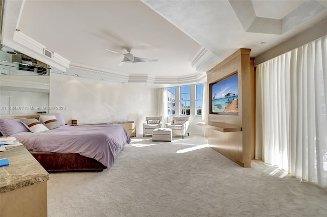 bedroom featuring a raised ceiling, crown molding, light colored carpet, and ceiling fan