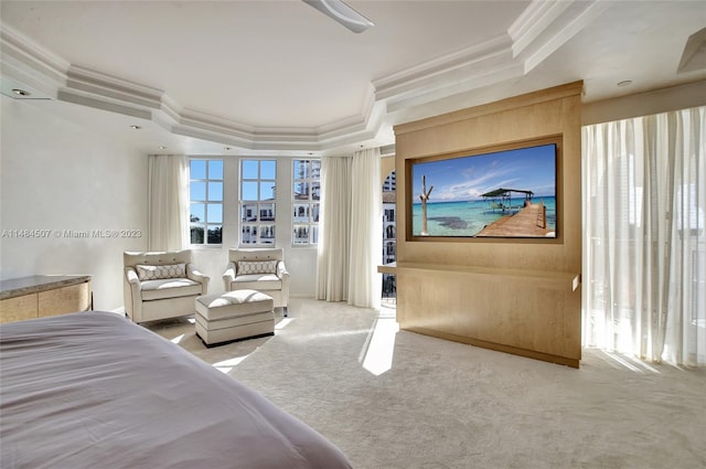 bedroom featuring ornamental molding, light colored carpet, and a tray ceiling