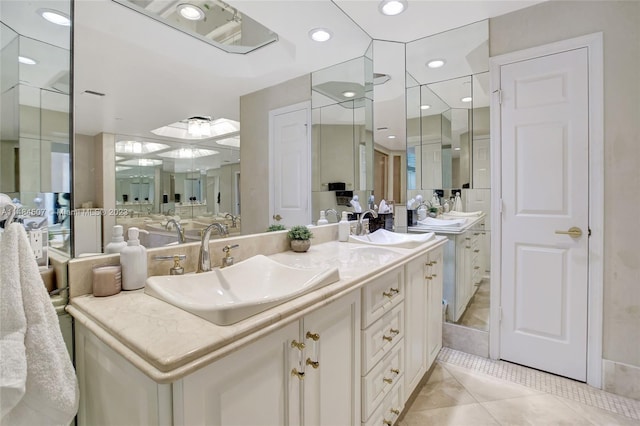 bathroom with vanity with extensive cabinet space, tile flooring, and double sink