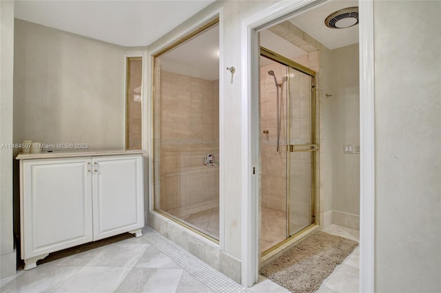 bathroom with tile floors and a shower with door