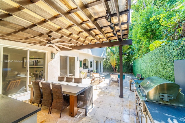 view of patio with area for grilling, grilling area, and ceiling fan