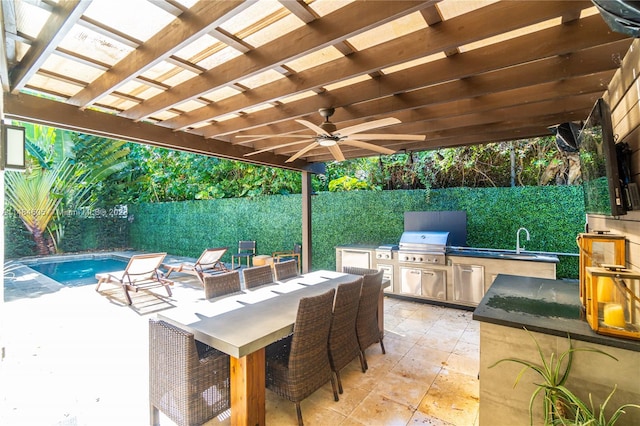 view of patio featuring exterior kitchen, ceiling fan, a pergola, a fenced in pool, and grilling area