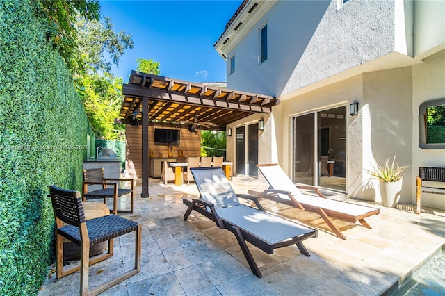 view of patio / terrace featuring an outdoor fireplace and a pergola