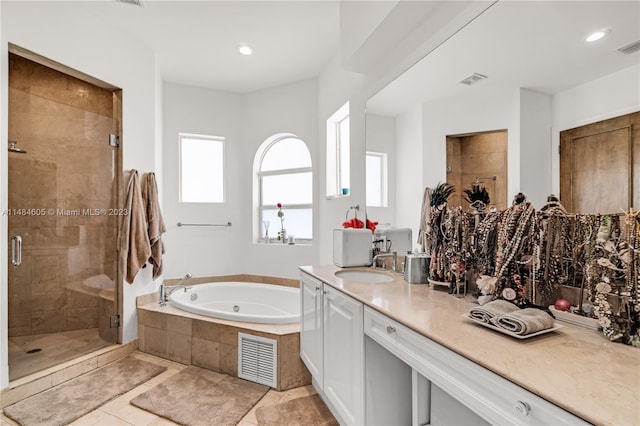 bathroom featuring vanity, plus walk in shower, and tile floors