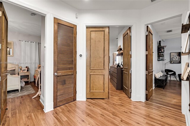 corridor featuring light hardwood / wood-style floors