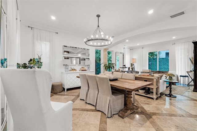 tiled dining space featuring an inviting chandelier and ornamental molding