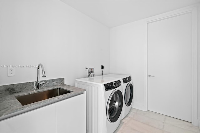 laundry room with separate washer and dryer, sink, and light tile patterned floors