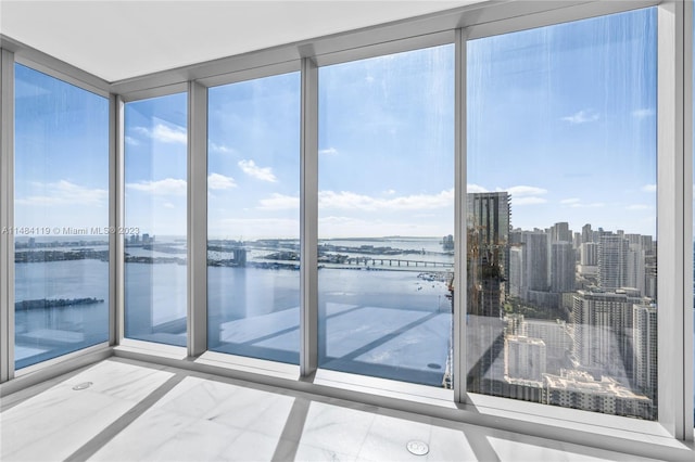 entryway with a water view, floor to ceiling windows, and a wealth of natural light