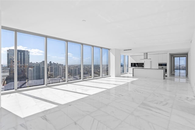 unfurnished living room featuring expansive windows