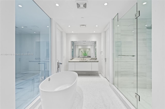 bathroom with vanity, tile patterned floors, and separate shower and tub