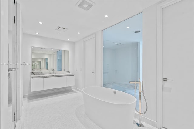 bathroom with vanity, tile patterned floors, and a bathing tub