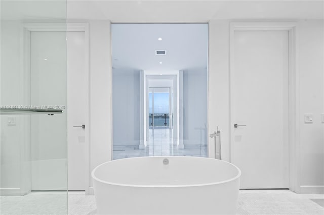 bathroom with independent shower and bath and tile patterned floors