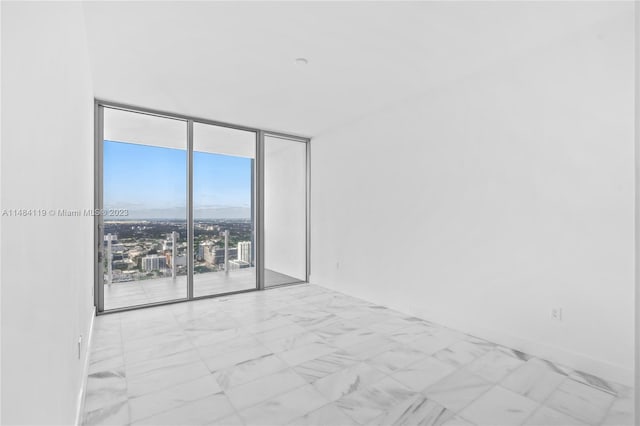 spare room with floor to ceiling windows