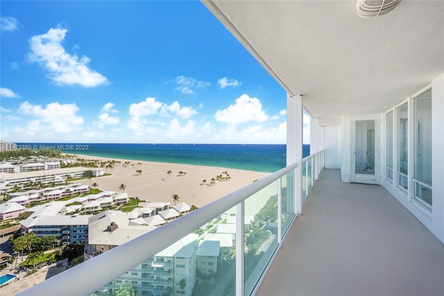 balcony featuring a water view and a view of the beach