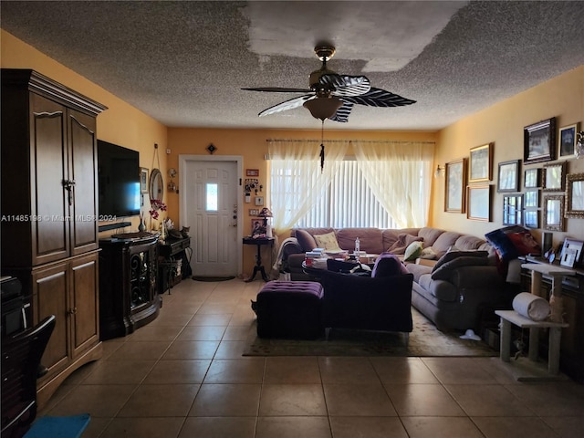 tiled living room with ceiling fan and a textured ceiling