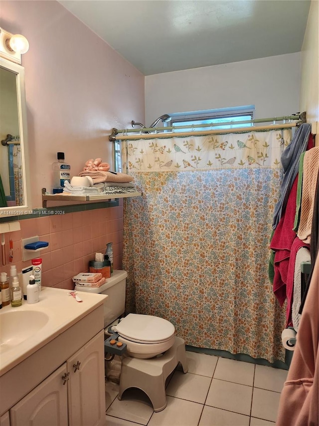 bathroom with vanity, walk in shower, tile walls, toilet, and tile patterned floors